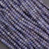 Close-up of purple beads on a gray background