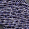 Close-up of purple beads on a dark background