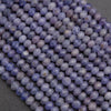 Close-up of purple beads on a dark background