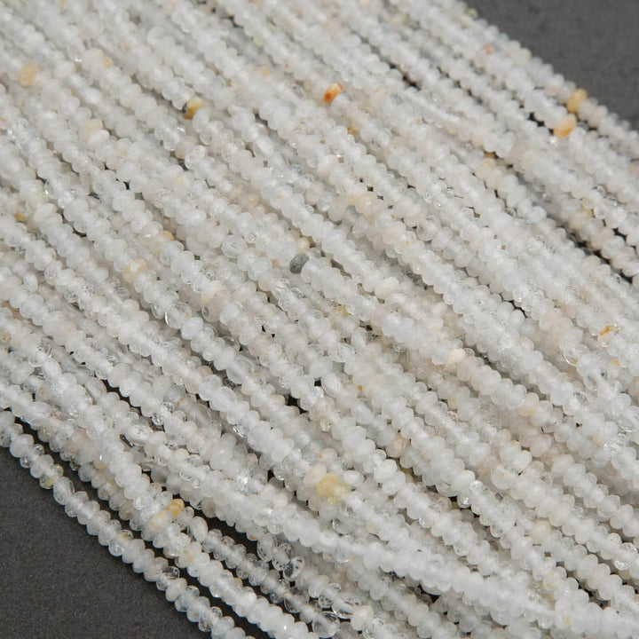 Clear faceted rondelle shape beads with yellowish inclusions.