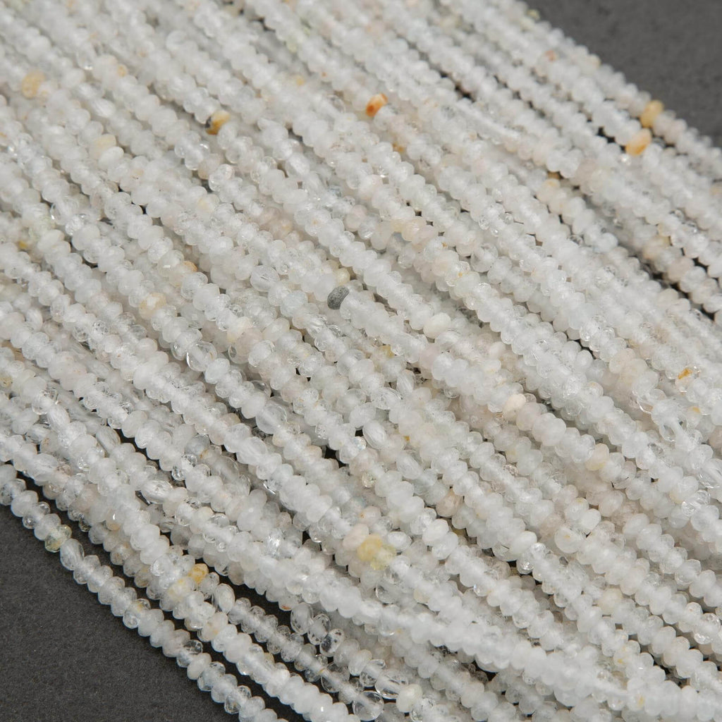 Clear faceted rondelle shape beads with yellowish inclusions.