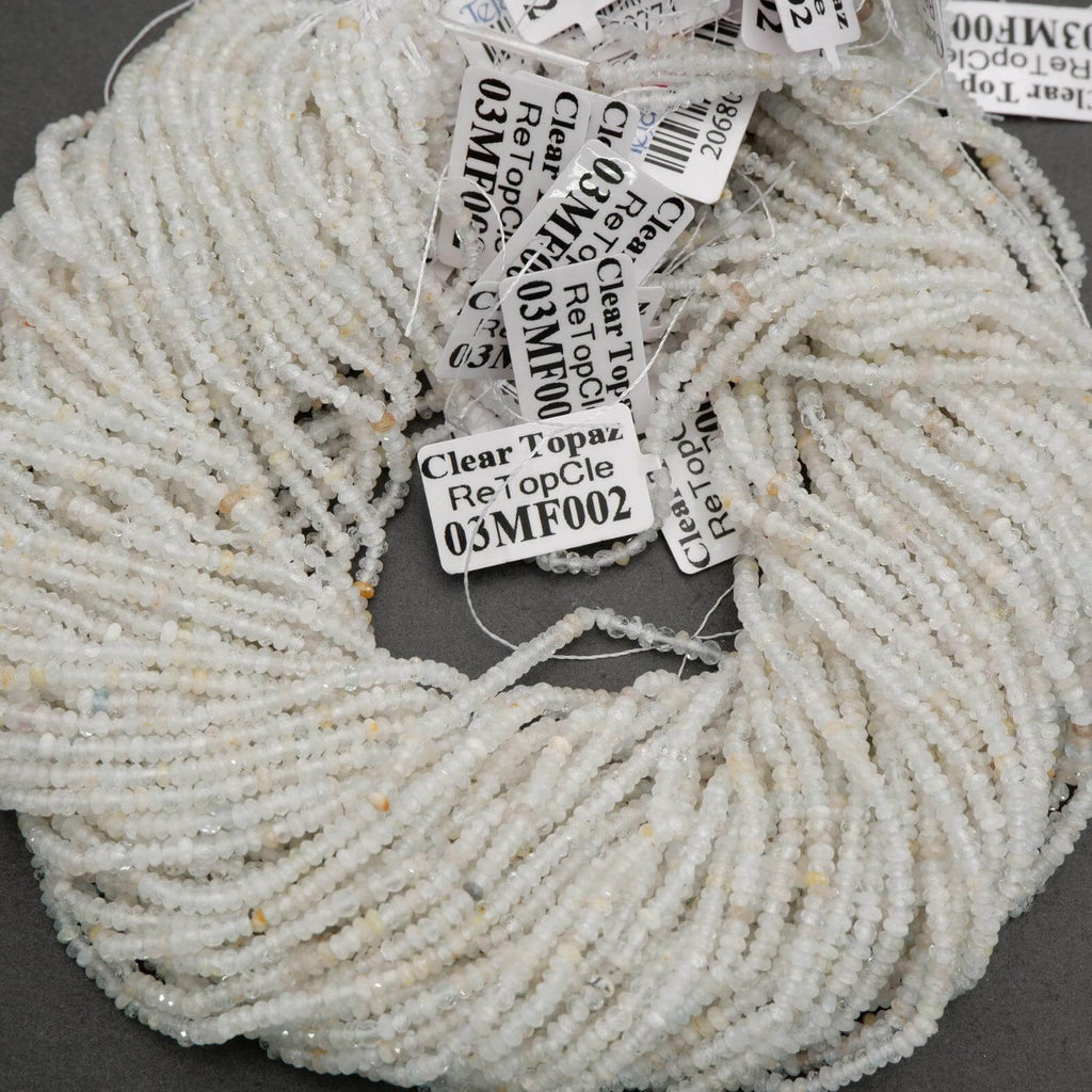 Clear faceted rondelle shape beads with yellowish inclusions.