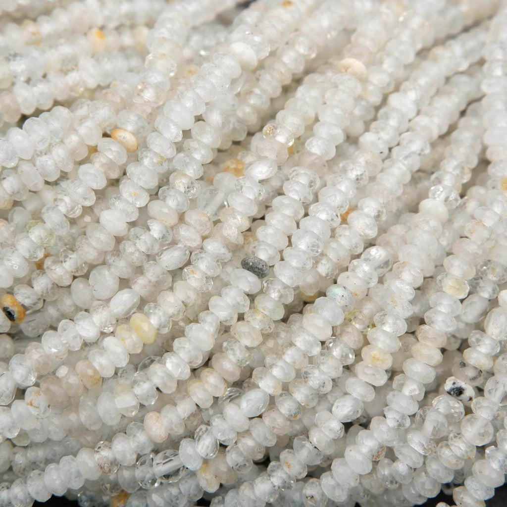 Clear faceted rondelle shape beads with yellowish inclusions.