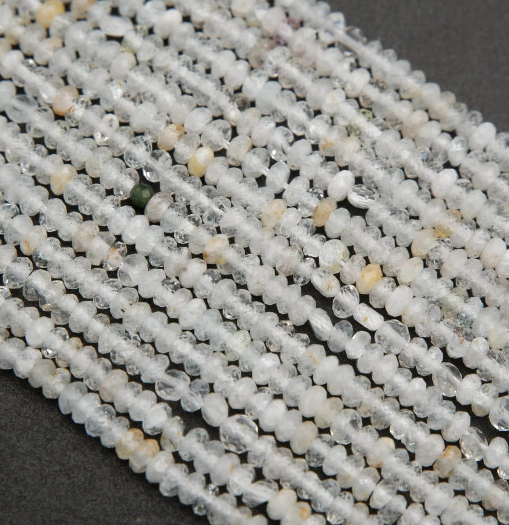 Clear faceted rondelle shape beads with yellowish inclusions.