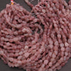 Close-up of pink beads on a dark background