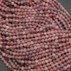 Close-up of pink beads on a dark background