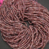Close-up of a ball of pink yarn on a dark surface