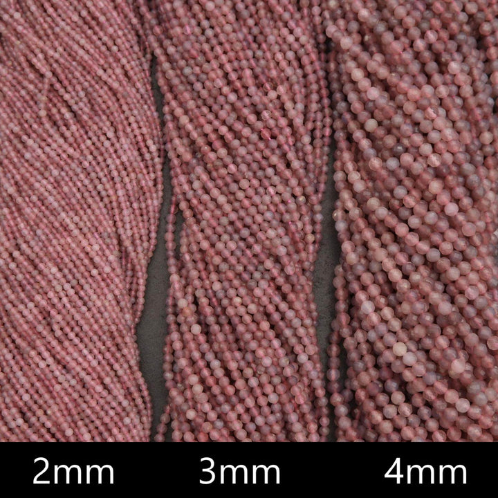 Close-up of pink beads with size labels '2mm', '3mm', and '4mm' on a dark background.