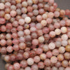 Close-up of pink and brown marbled beads on a gray background
