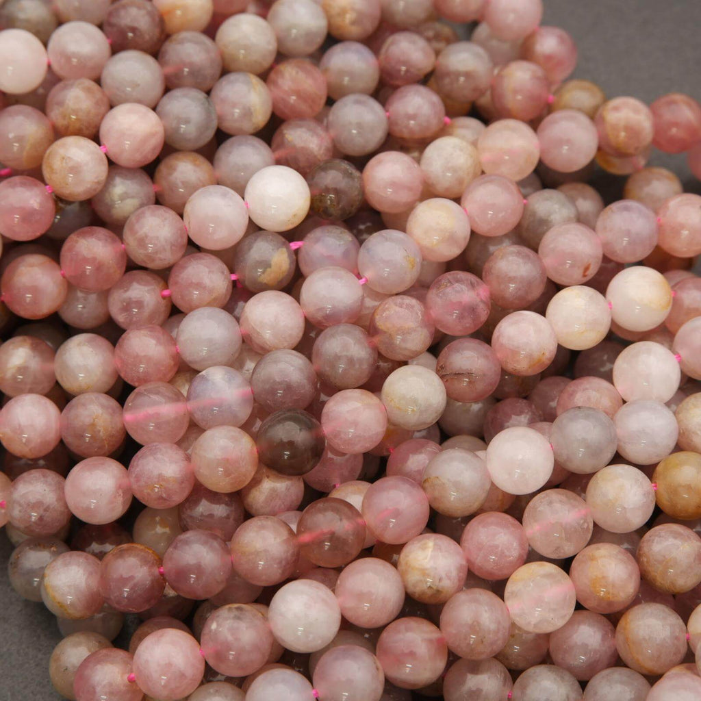 Close-up of pink and brown marbled beads on a gray background