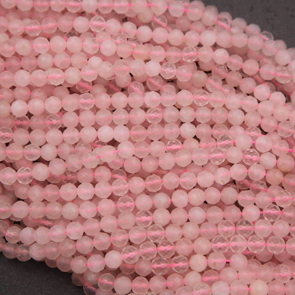 Close-up of pink beads on a string with a dark background