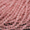 Close-up of pink beads on a dark background