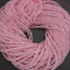 Pink beaded string on a dark background