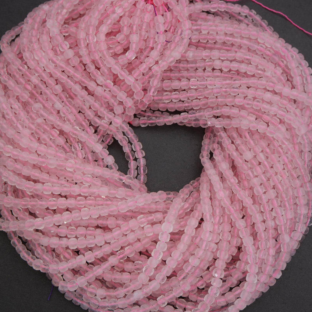Pink beaded string on a dark background