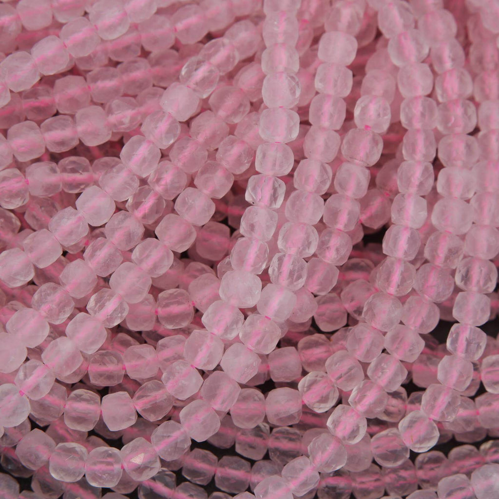 Close-up of pink glass beads on a dark background