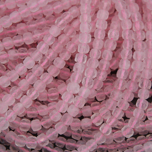 Close-up of pink glass beads on a dark background