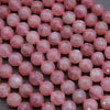 Close-up of pink beads on a dark surface