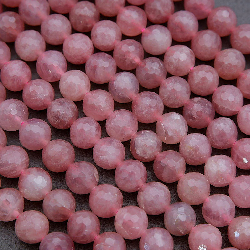 Close-up of pink beads on a dark surface