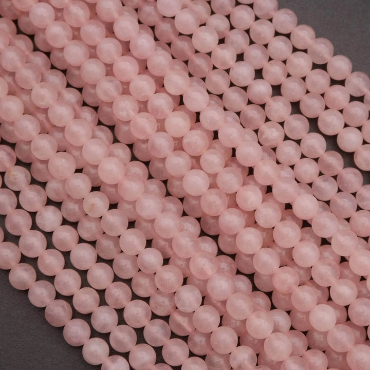 Close-up of pink beads on a dark surface