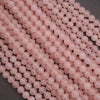 Close-up of pink beads on a dark surface