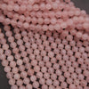 Close-up of pink beads on a dark background