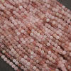 Close-up of pink and white beads on a dark background