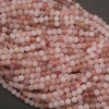 Close-up of pink beads with a dark background