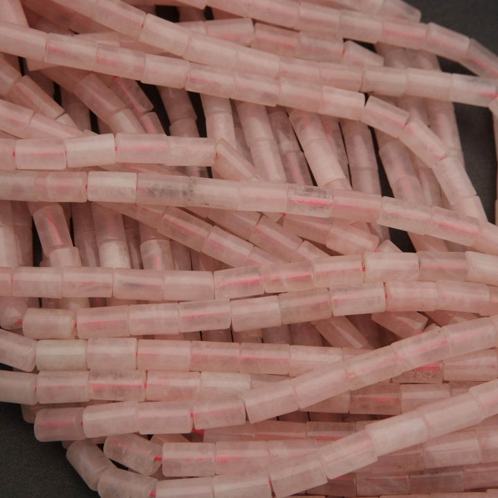 Close-up of pink and clear plastic straws on a dark surface