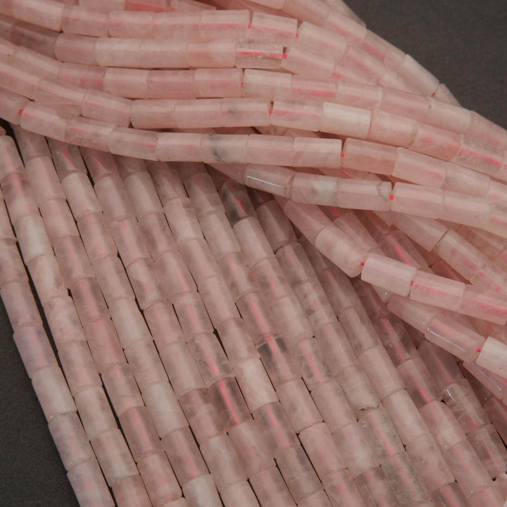 Close-up of pink and clear plastic tubes stacked together on a dark background