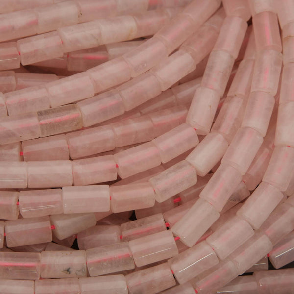 Close-up of pink cylindrical beads with red accents.