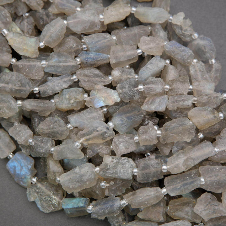 Close-up of raw labradorite stones on a gray background