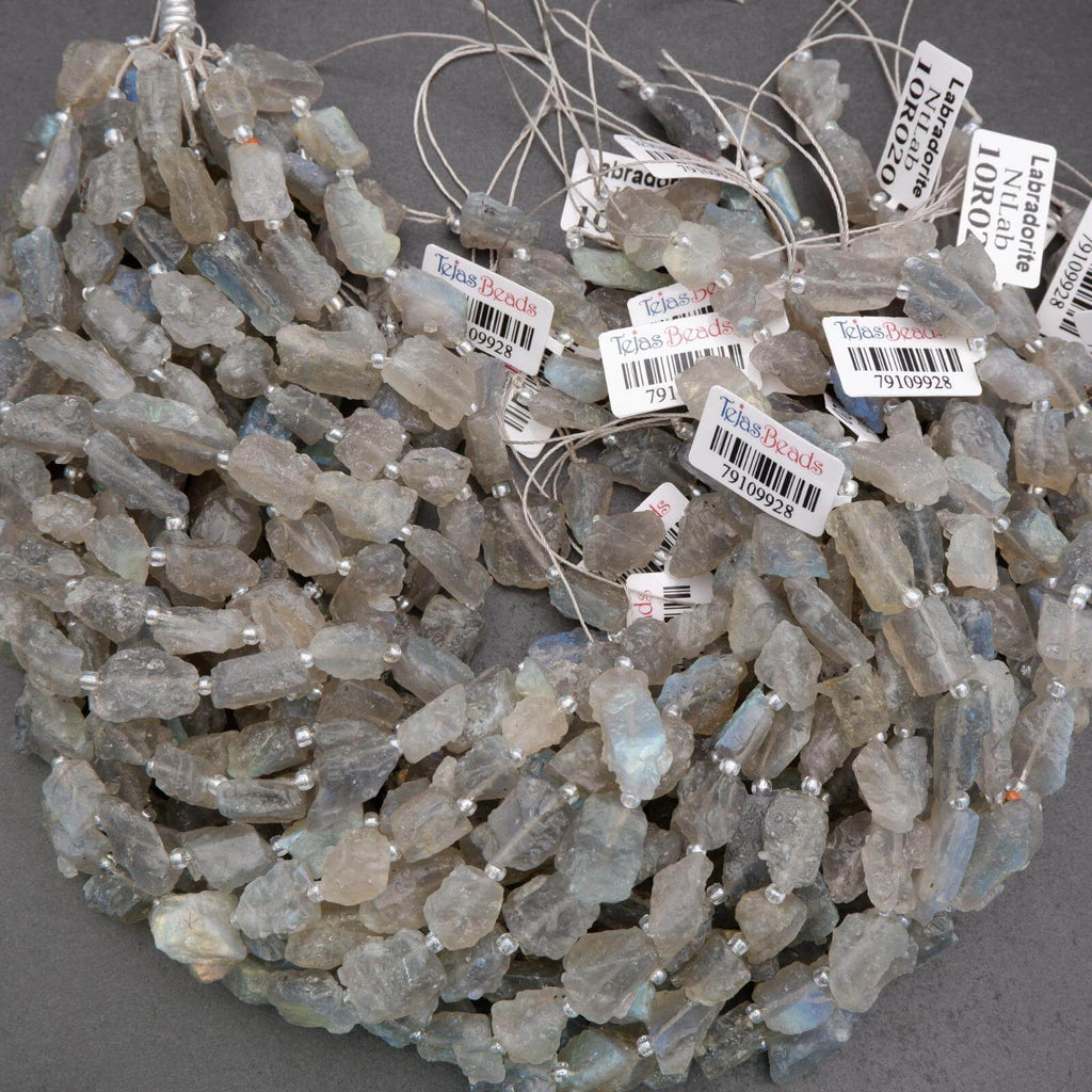 String of raw gemstones with labels on a gray background