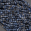Close-up of blue faceted beads on a gray background