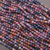 Close-up of multicolored round beads on a gray surface