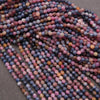 Close-up of multicolored beads on a dark surface