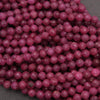 Close-up of purple beads on a gray background