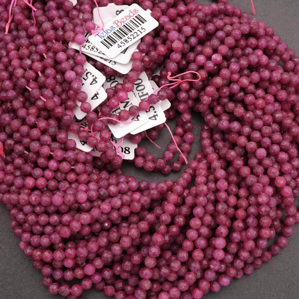 Close-up of pink beads with price tags on a gray background