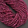 Close-up of a string of pink beads on a dark background