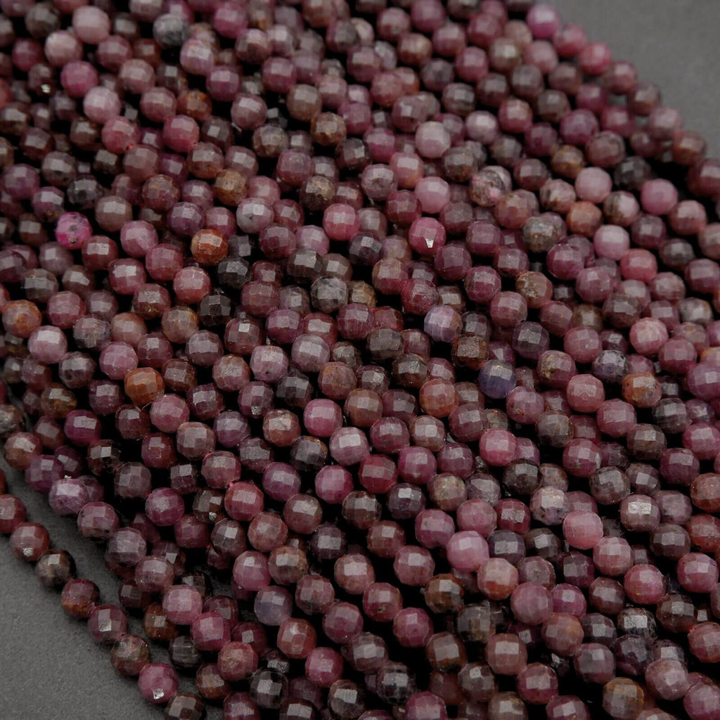 Close-up of a strand of faceted purple beads on a dark background