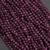 Close-up of a string of purple beads on a dark background
