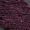 Close-up of purple beads on a dark background