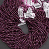 Purple beads with tags on a gray background