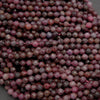 Close-up of faceted purple beads on a dark background