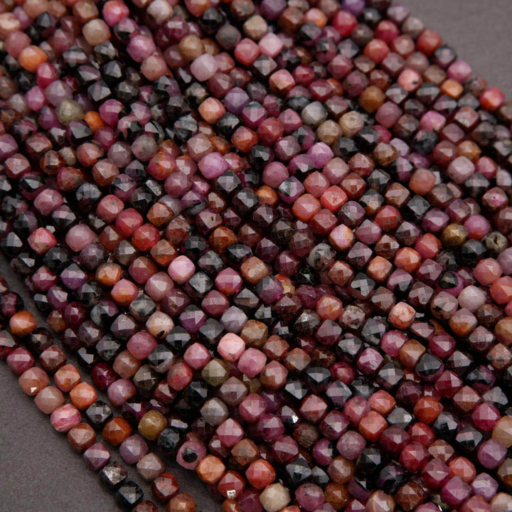 Strands of ruby beads with earthy red, plum, and dark accent tones.