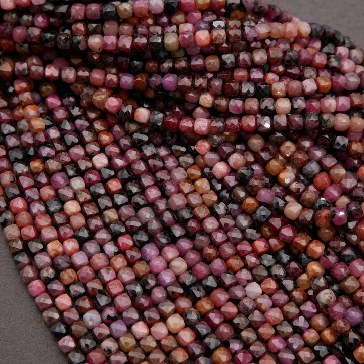 Detail view of ruby beads featuring mixed shades of pink, wine, and black.