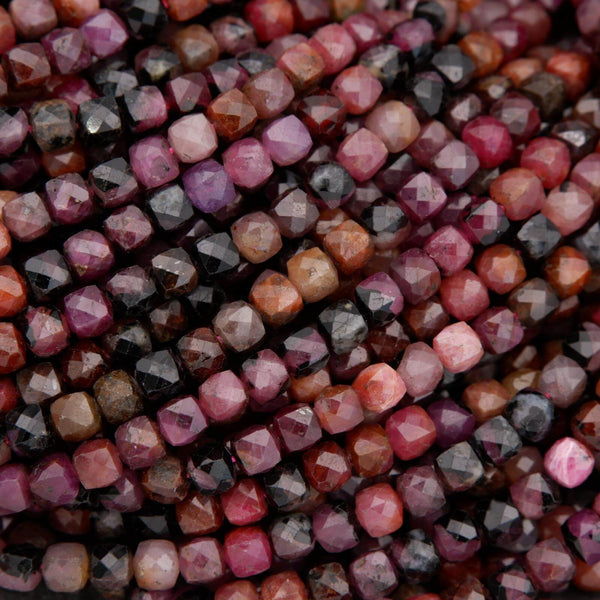 Close-up of natural ruby beads showing faceted surfaces and rich color variation.