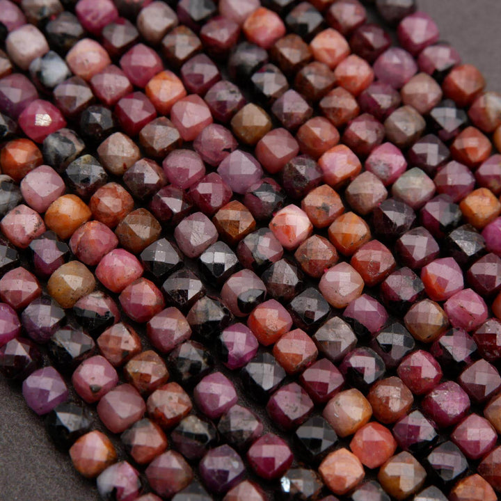 Natural ruby beads with small faceted cuts and organic color variation.