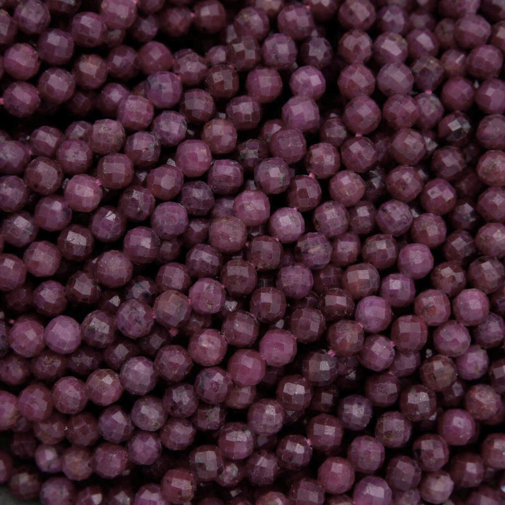 Close-up of purple beads with a dark background