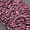 Close-up of pink and black beads on a gray background