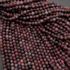 Close-up of a string of pink and brown faceted beads.
